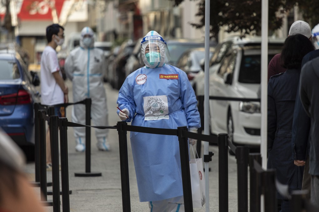 Workers in personal protective equipment prepare for a round of Covid-19 testing during a lockdown in Shanghai on Thursday. Photo: Bloomberg