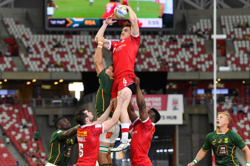 Canada’s Phil Berna reaches for the ball during the Singapore Rugby Sevens match between South Africa and Canada. Photo: AFP