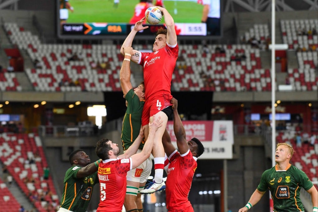 Canada’s Phil Berna reaches for the ball during the Singapore Rugby Sevens match between South Africa and Canada. Photo: AFP