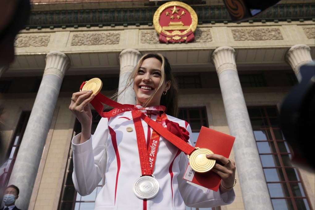 Olympic gold medalist Eileen Gu poses with her three medals before a commendation ceremony at the Great Hall of the People. Photo: AP