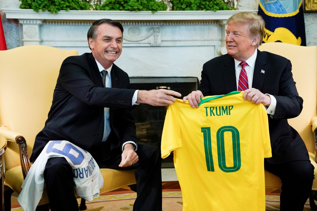 Brazil’s President Jair Bolsonaro presents a Brazil national soccer team jersey to US President Donald Trump at the White House in March 2019. Photo: Reuters