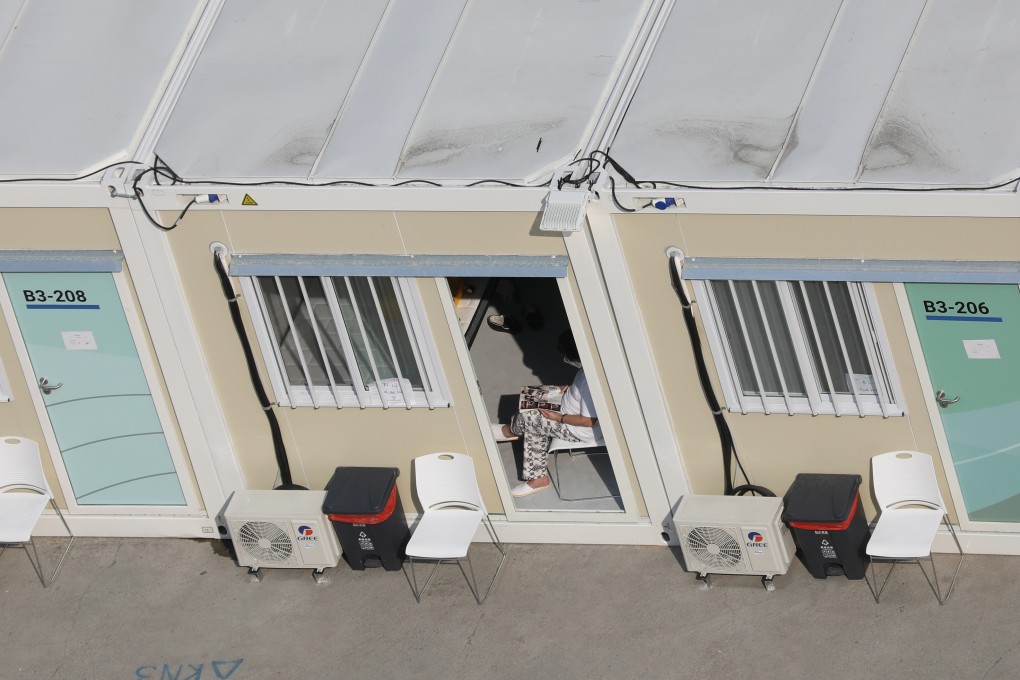 A Covid-19 confirmed patient reads in his room at the Tsing Yi Community Isolation Facility in Hong Kong. Photo: Yik Yeung-man