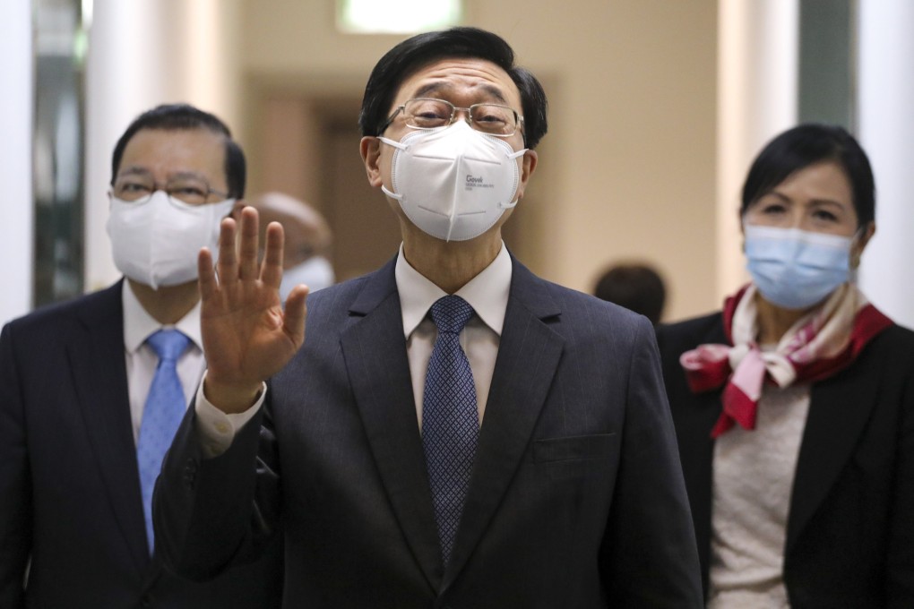 John Lee leaves his press conference on Saturday with his campaign manager, Tam Yiu-chung (left).  Photo: Jelly Tse