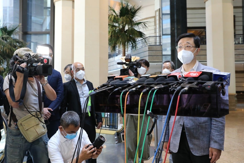 Chief executive hopeful John Lee meets the press at Central Plaza in Wan Chai on Sunday. Photo: Jelly Tse