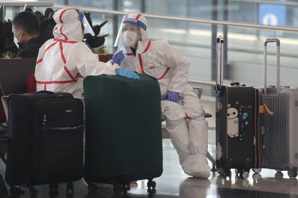 PPE-clad travellers wait to check in at Hong Kong International Airport on April 3. Photo: Xiaomei Chen
