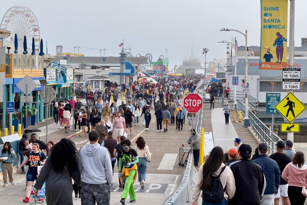 People visit the Santa Monica Pier in California on March 25. The great debate in the market right now is whether the Fed is ready to squeeze down so hard on inflation that it is prepared to tip the economy back into hard times. Photo: AFP