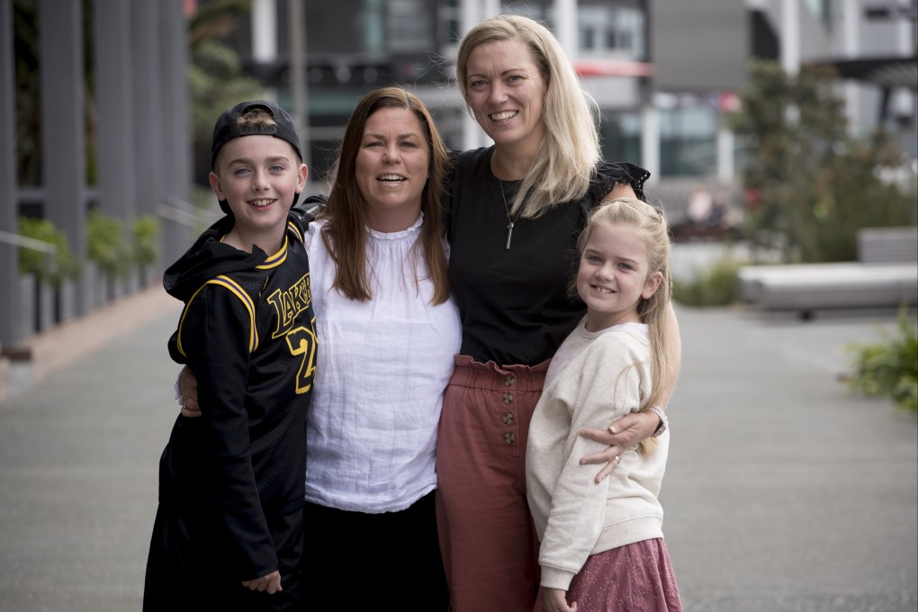 Jane Cheeseman (in black) and her two children were reunited with her sister after they arrived from Australia on Wednesday. Photo: The New Zealand Herald