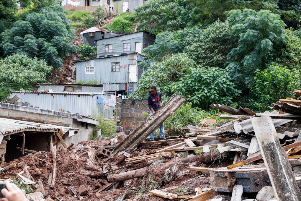 Residents salvage the remains of what use to be the United Methodist Church of South Africa in Claremont, near Durban. 259 people have been killed following heavy rains. Photo: AFP