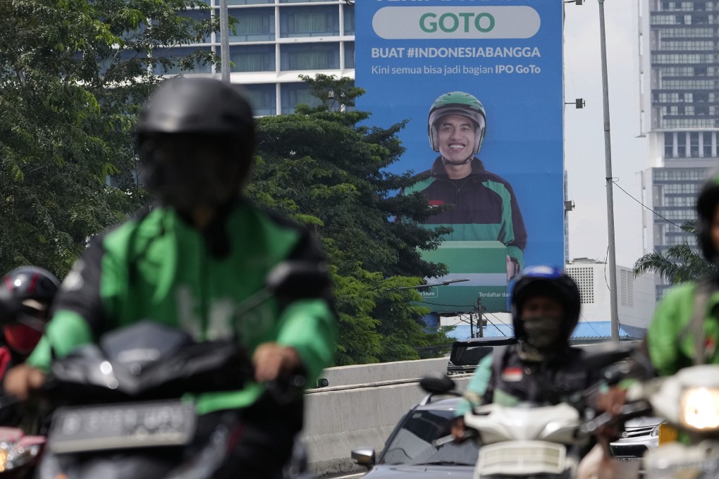 Motorcyclists travel past a billboard advertising GoTo’s IPO in Jakarta. Photo: Bloomberg