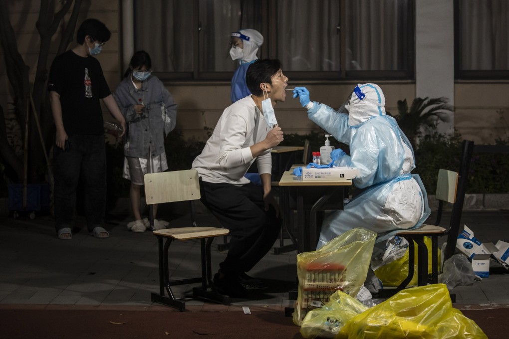 A medical worker gives a PCR swab to a Shanghai resident as the city combats its worst outbreak of the pandemic. Photo: Bloomberg