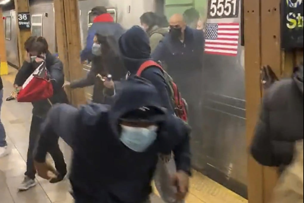 Passengers run from a subway car in a station in the Brooklyn borough of New York on Tuesday. Photo: Will B. Wylde via AP