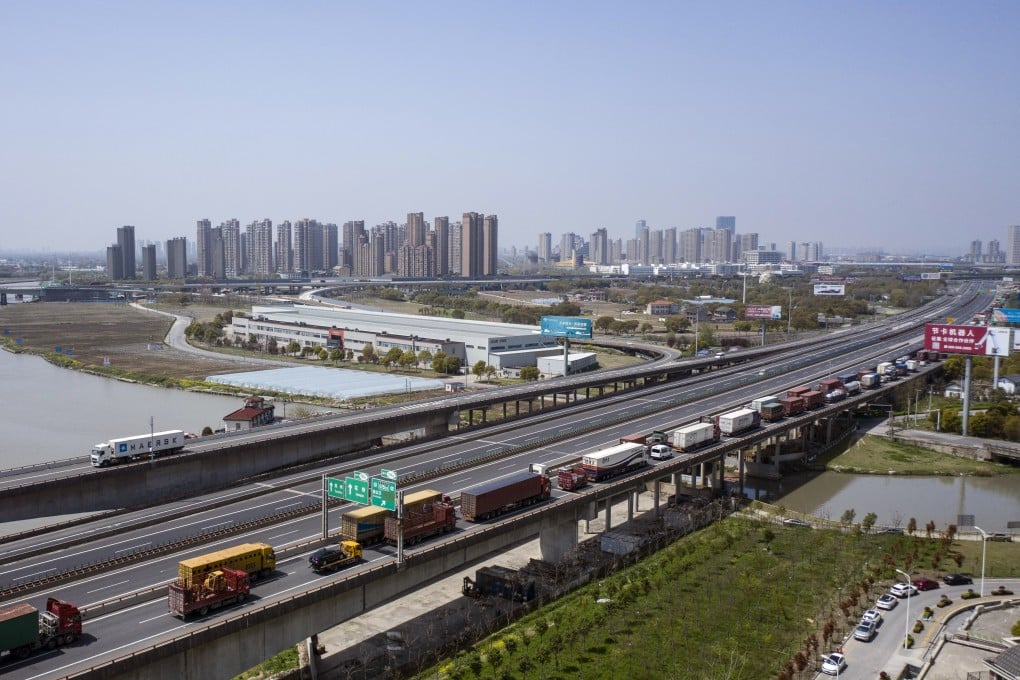 Trucks wait to pass through a checkpoint on a highway leading from Shanghai, China, on March 30. Photo: Bloomberg
