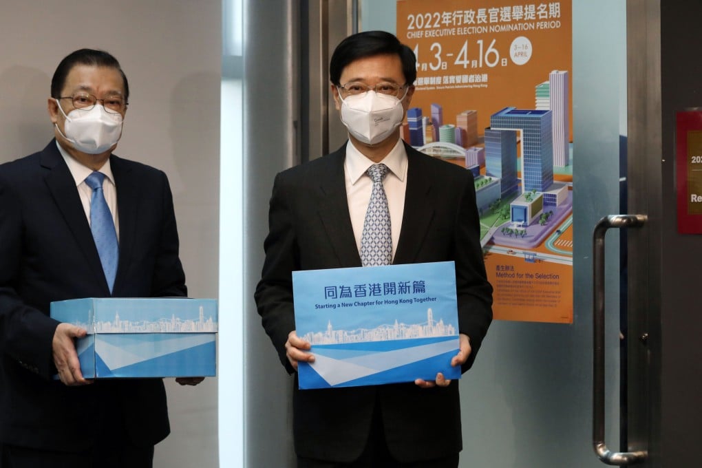 John Lee (right) submits nominations he received for the chief executive election with campaign chief Tam Yiu-chung
at the Electoral Affairs Commission office at City Gallery on Wednesday. Photo: Yik Yeung-man