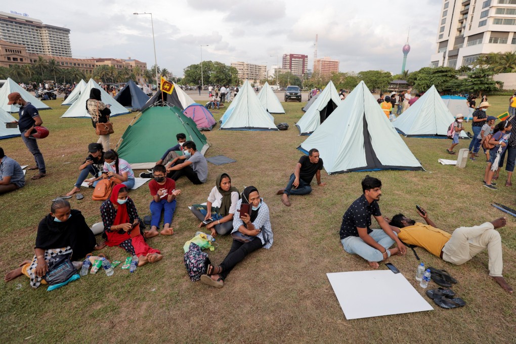 Demonstrators sit in a protest area, dubbed the Gota-Go village, where people are gathering in opposition to Sri Lanka’s President Gotabaya Rajapaksa near the Presidential Secretariat, amid the country’s economic crisis, in Colombo, Sri Lanka on Monday. Photo: Reuters