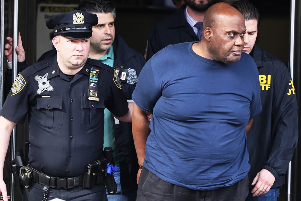 New York subway shooting suspect Frank James is led away by police after being arrested on Wednesday. Photo: TNS