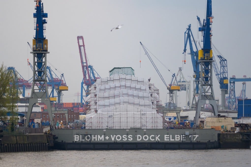 The luxury yacht Dilbar lies completely covered at the dock in Hamburg, Germany on Wednesday. Photo: dpa
