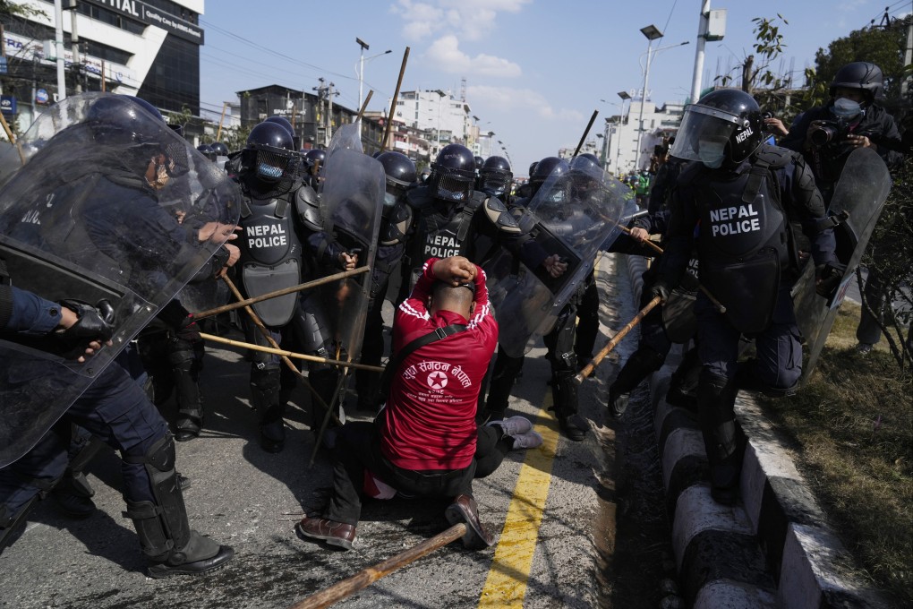 Nepalese police baton-charge a protester opposing a US aid agency’s US$500 million grant for Nepal outside the parliament in Kathmandu on February 27. The US grant, meant to improve roads and other infrastructure in Nepal, is opposed by the Communist parties, two of which are in the governing coalition government. Photo: AP