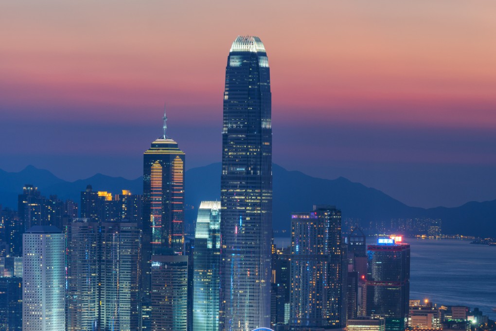 Skyscrapers seen from Victoria Harbour at dusk. Pandemic restrictions have cast a shadow over Hong Kong’s “world city” status, but its global roots remain deep. Photo: Getty Images
