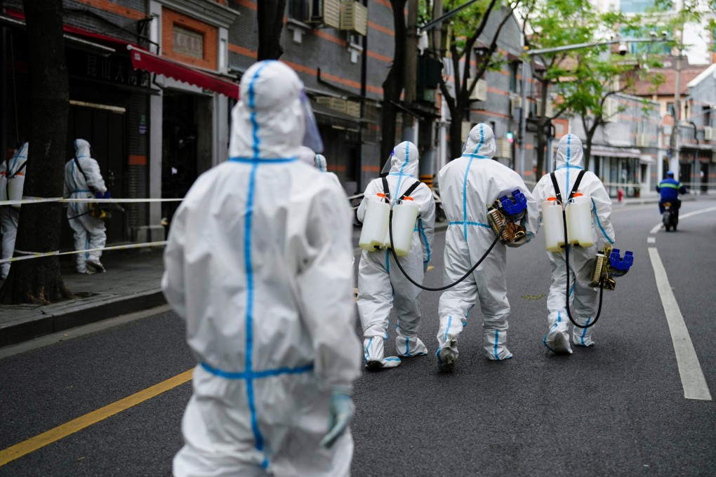 Workers in protective suits disinfect an old residential area of Shanghai on Friday amid the city’s Covid-19 lockdown. Photo: Reuters