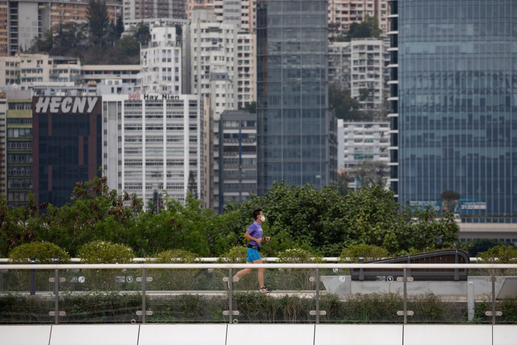 A man wears a mask as he jogs near the site of the former Kai Tak Airport runway in Hong Kong on March 30. Photo: EPA-EFE
