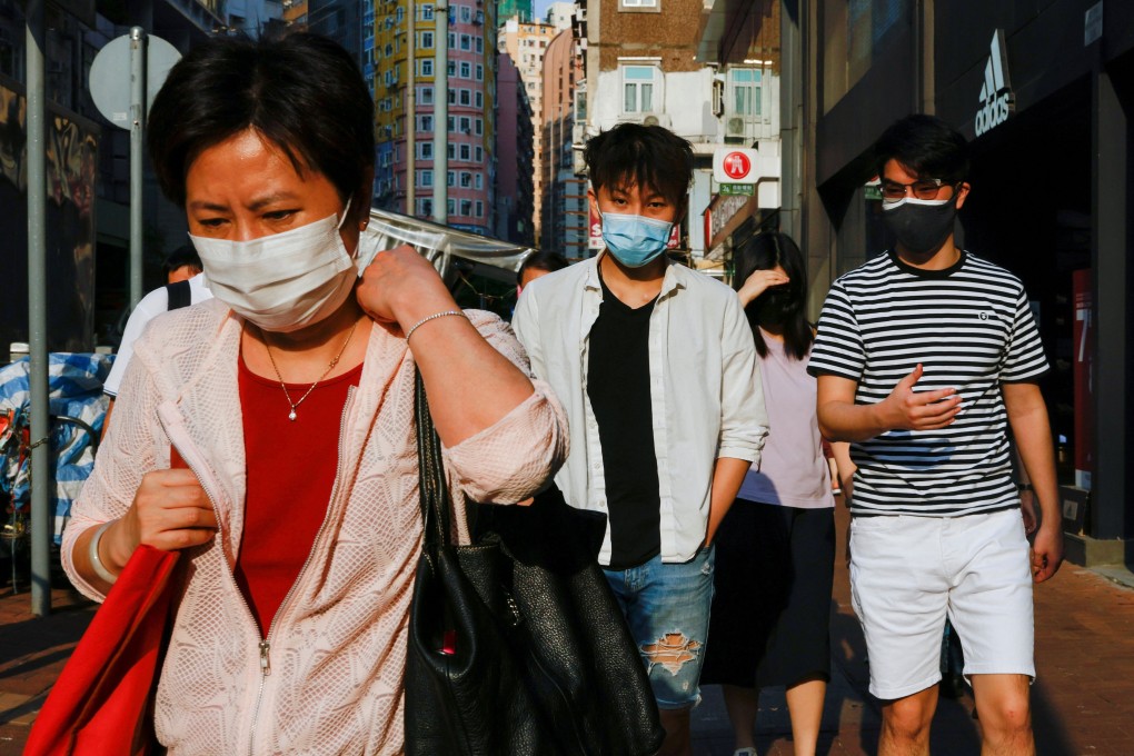 People wearing face masks walk through Wan Chai on Thursday. Photo: Reuters