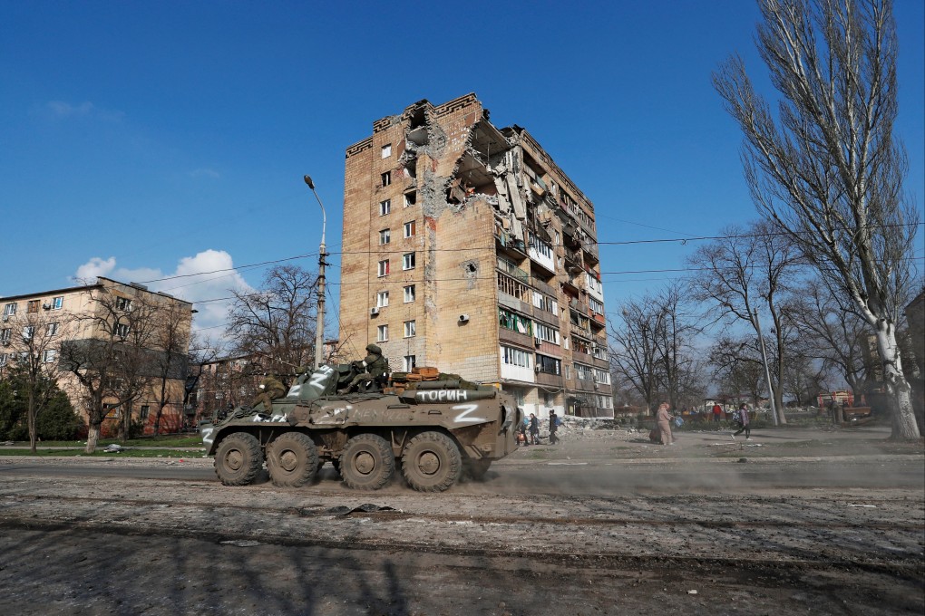 Service members of pro-Russian troops ride an armoured vehicle in Mariupol, Ukraine, on Friday. Photo: Reuters
