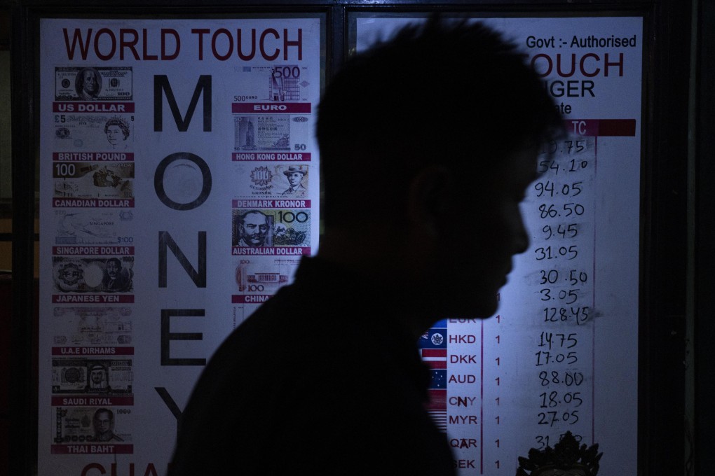 A man walks in front of a money exchange venue in Kathmandu, Nepal. Photo: AP
