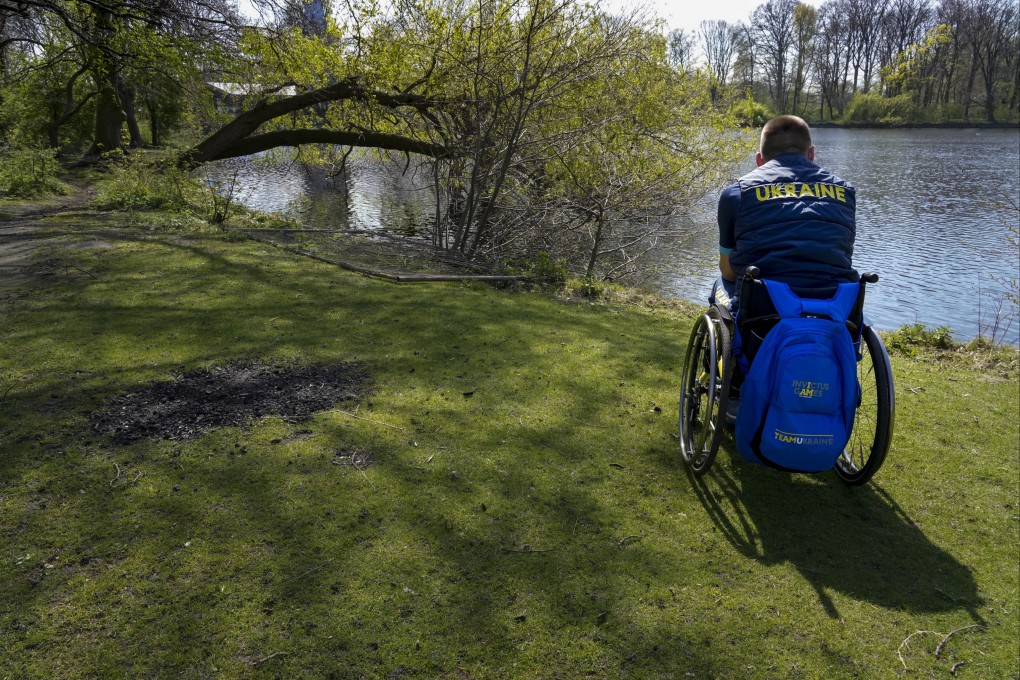 A member of Team Ukraine looks out over a lake at the Invictus Games venue in The Hague, Netherlands. Photo: AP