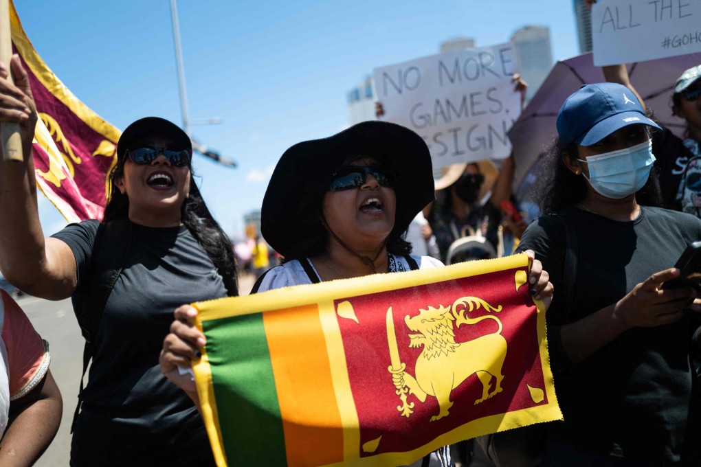 People shout slogans during an anti-government demonstration near the president’s office in Colombo on Saturday, demanding President Gotabaya Rajapaksas resignation over the country’s crippling economic crisis. Photo: AFP
