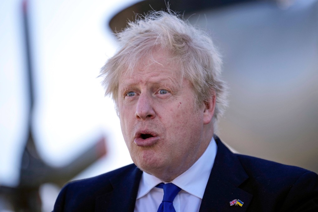 Britain’s Prime Minister Boris Johnson reacts as he meets with HM Coastguard and Royal Navy crews and technical staff at Lydd Airport, in south east England on Thursday. Photo: Pool/AFP