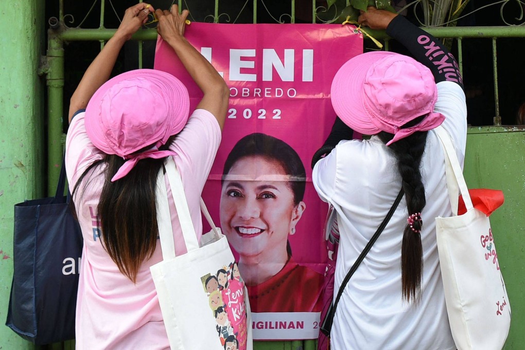 Supporters of Leni Robredo hang a poster in Las Pinas, suburban Manila. Photo: AFP