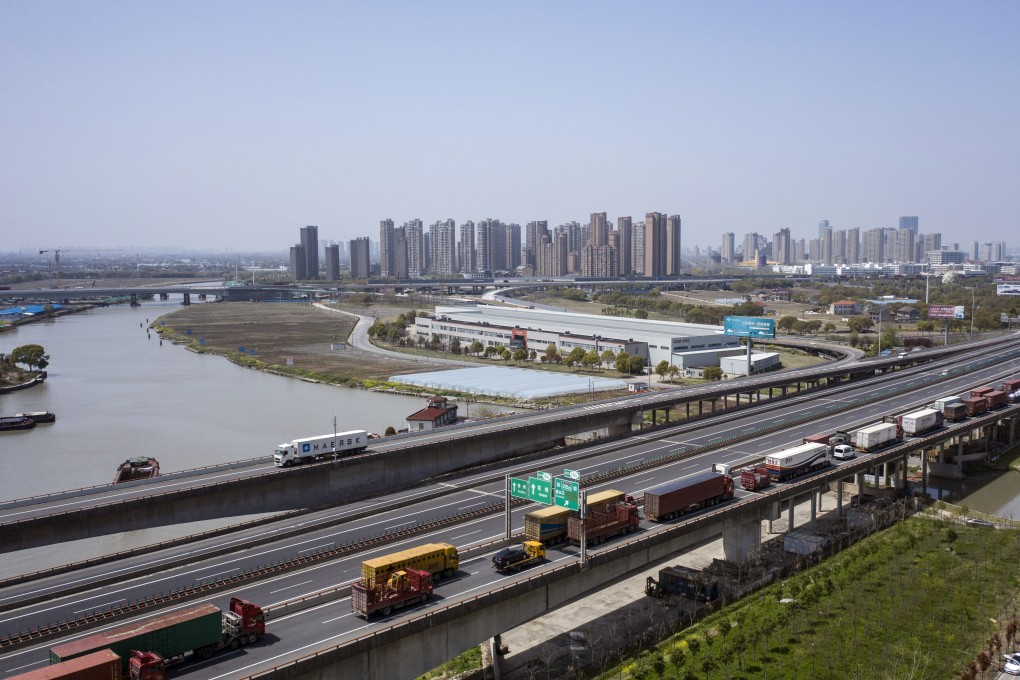 Trucks wait to pass through a checkpoint on a highway in China. Photo: Bloomberg