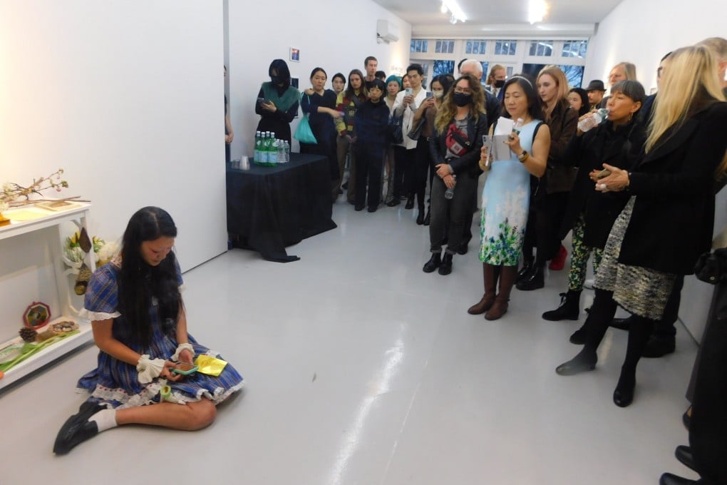 Stephanie Mei Huang (left), artist and curator of the “With Her Voice, Penetrate Earth’s Floor” exhibition at New York’s Eli Klein Gallery in memory of Christina Yuna Lee, ignites risograph joss paper to activate the opening of the exhibition. Photo: Judy Chiu
