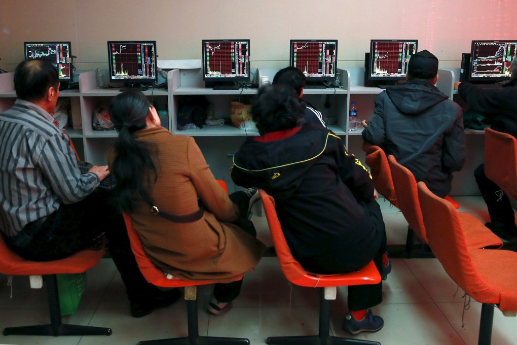 Investors look at computer screens showing stock information at a brokerage house in Shenyang in pre-pandemic days. Photo Reuters