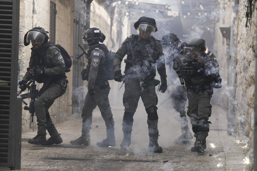 Palestinians shoot fireworks at Israeli police in the Old City of Jerusalem on Sunday. Photo: AP
