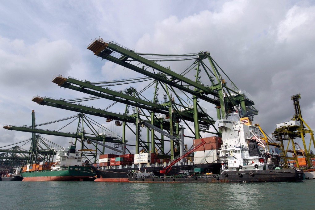 A container ship is refuelled at the dockside in Singapore in 2012. Photo: EPA