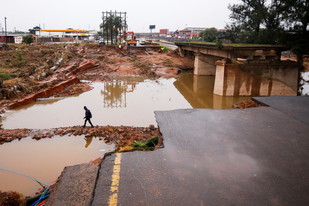 A man walks around a damaged bridge caused by flooding in Umlazi near Durban, South Africa on April 16. Photo: Reuters