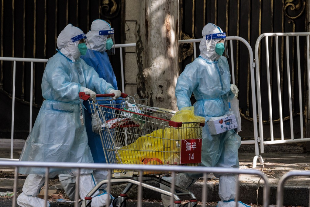 People in protective gear walk on a street in Shanghai, China, on Monday. Photo: EPA-EFE