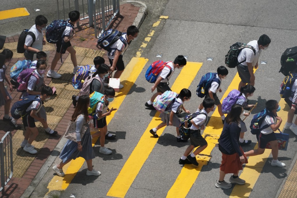Primary school pupils in Tseun Wan cross the road, led by their teacher, in 2021. Photo: Felix Wong