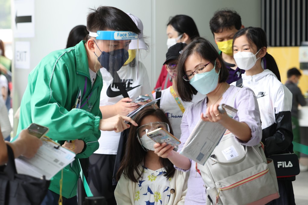 Parents take their children to receive a BioNTech shot at the Children Community Vaccination Centre at Hong Kong Children’s Hospital in Kai Tak. Photo: Jelly Tse