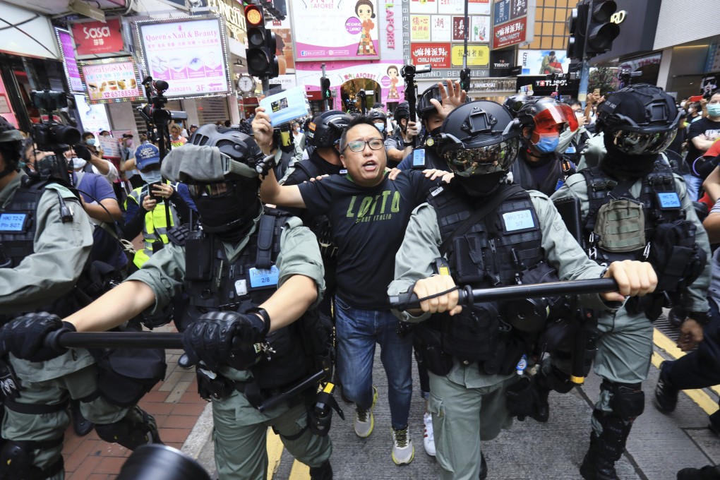 People Power activist Tam Tak-chi (centre) is arrested in Causeway Bay during a 2020 protest. Photo: May Tse