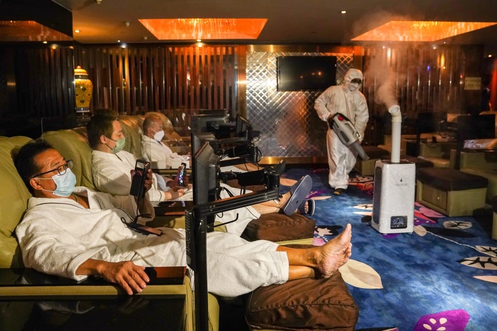 An employee at a spa massage parlour in Tsim Sha Tsui disinfects the premises on Wednesday ahead of the relaxation of Covid-19 social-distancing restrictions. Photo: Sam Tsang
