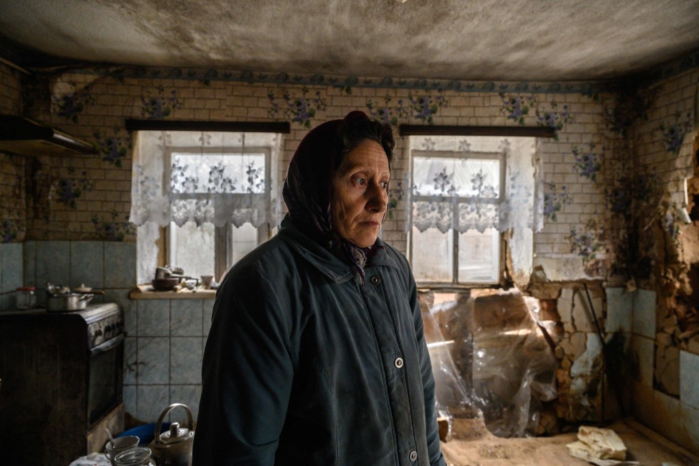 Tanya Los, 57, stands in her house near damage caused by a rocket is understood to have been launched from a Soviet-era BM-27 Uragan launcher. Photo: AFP