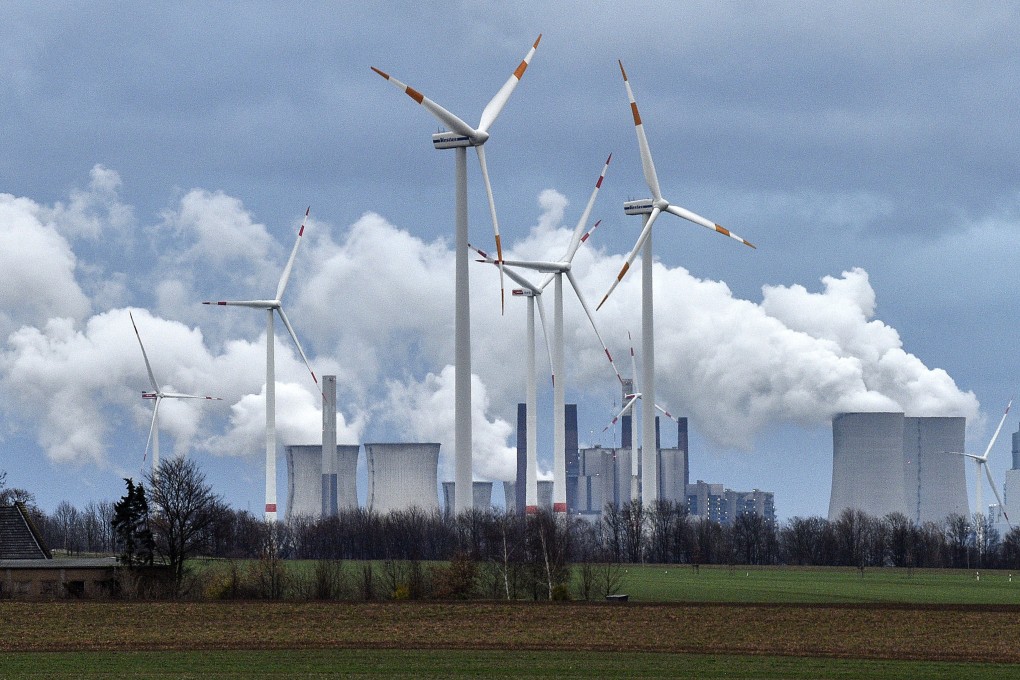 Wind turbines are seen in front of a coal-fired power plant in Germany in December 2018. The country has committed to increasing its wind power production. Photo: AP