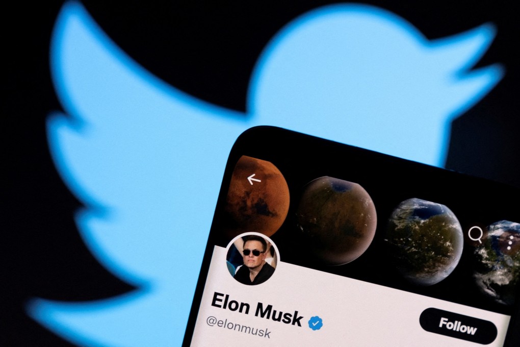 Elon Musk’s twitter account is seen on a smartphone in front of the Twitter logo. Photo: Reuters