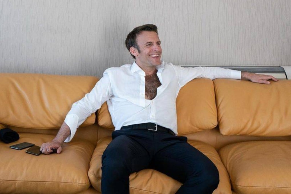 French President Emmanuel Macron reclines on a sofa, the top four buttons of his white shirt undone to reveal a full pelt of dark chest hair - an image that saw social media users compare him to Sean Connery and Tarzan. Photo: Soazig de la Moissonnière