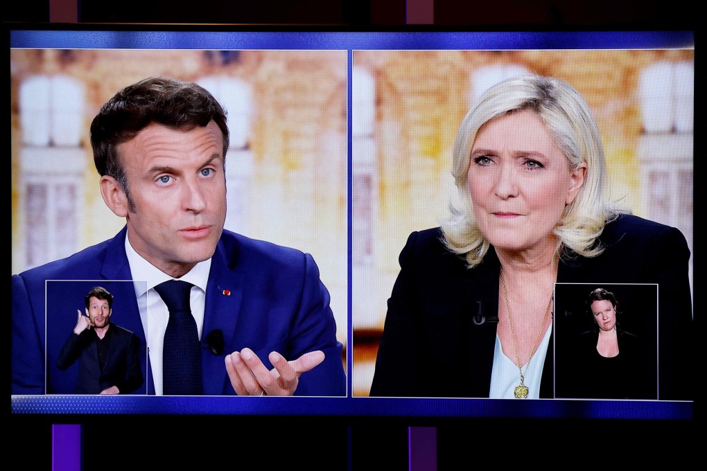 TV screens display a live televised debate between French President Emmanuel Macron and rival candidate Marine Le Pen on Wednesday. Photo: AFP