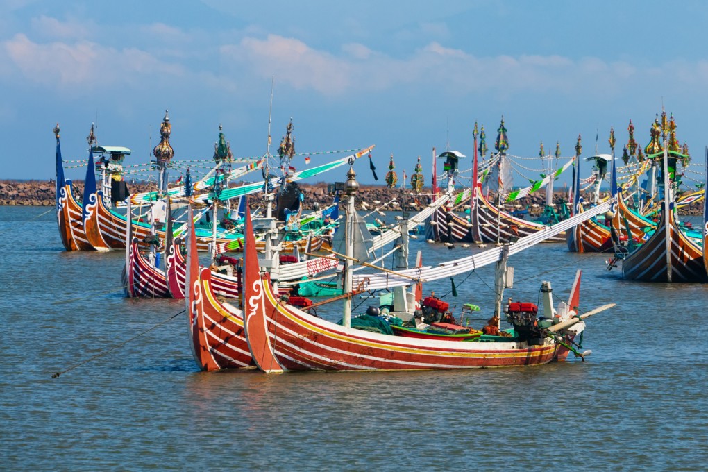 Multicoloured fishing boats moor near the village of Perancak on the west coast of the Indonesian island of Bali. Photo: Getty Images / iStockphoto