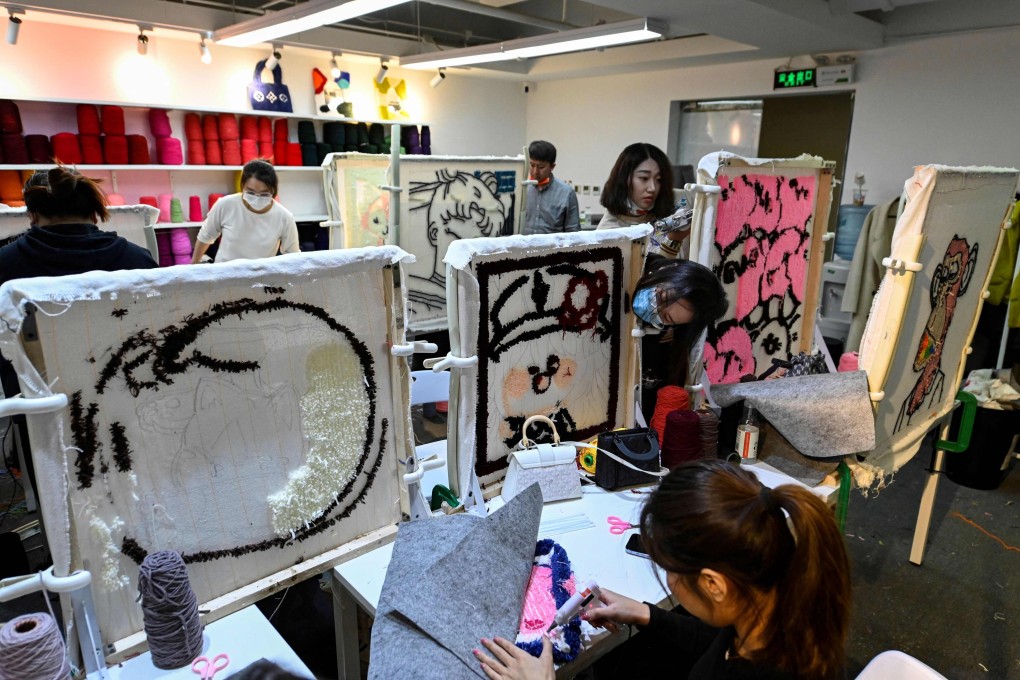 Participants at a tufting workshop in Beijing make mats and rugs. Photo: AFP