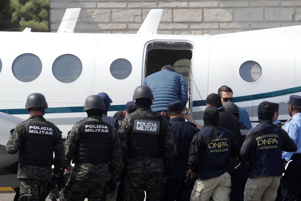 Honduras’ former president Juan Orlando Hernandez boards a plane to the United States. Photo: Reuters